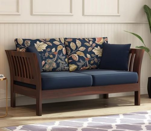 Solid wooden two seater sofa with floral printed cushions and walnut finish for living room décor