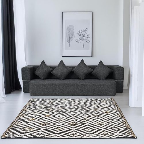 Modern black folding couch bed with cushions in a minimalist living room