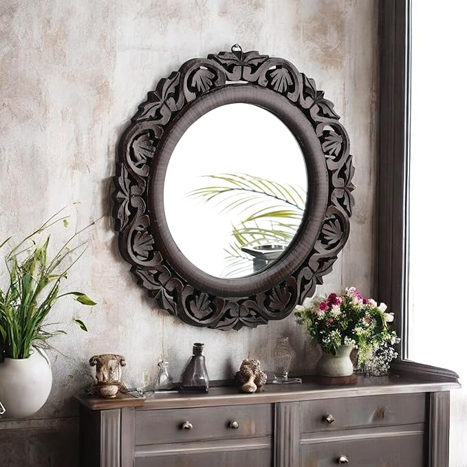 Elegant round wood frame mirror with intricate floral carving design in walnut finish, wall-mounted above a wooden dresser, perfect for home and office décor.