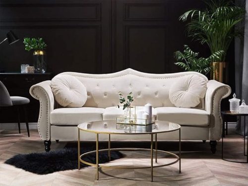 Beige velvet sofa bed couch with tufted backrest and round cushions