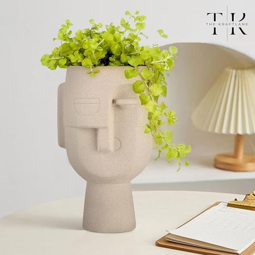 Ceramic Human Face Vase in beige finish with green plant, modern artistic home décor piece.