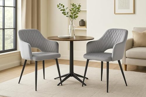 Light grey upholstered Dining Chair with Armrest around a round wooden table