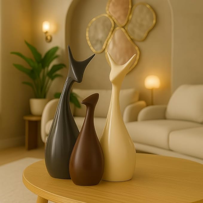 Modern ceramic home decor statues in matte finish, deer family figurines placed on a wooden table in a stylish living room.