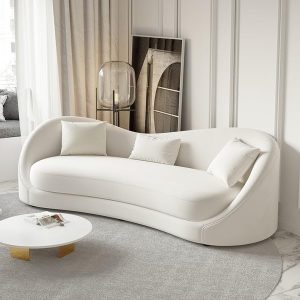 A modern white curved sofa, also known as a circle sofa couch, in a bright and minimalist living room.