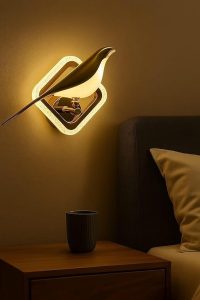 	A decorative Bedroom Lamp Wall sconce shaped like a glowing gold bird in a square frame, casting warm light above a nightstand.